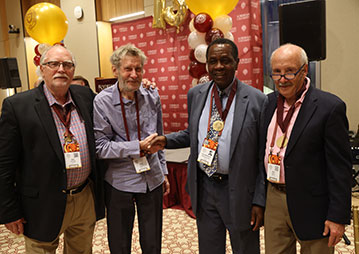 Four men smiling. Links to What to Give