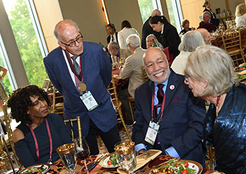 Four people sitting at a table. Links to Beneficiary Designations