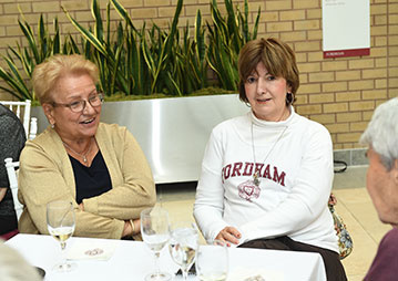 People having a conversation at a table. Links to Gifts of Appreciated Securities